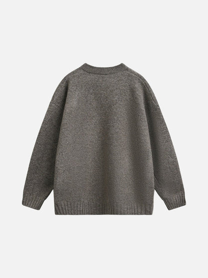 Light grey knit jumper showing its ribbed hem and cuffs