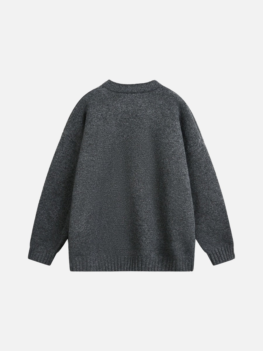 Relaxed light grey knitted jumper laid flat