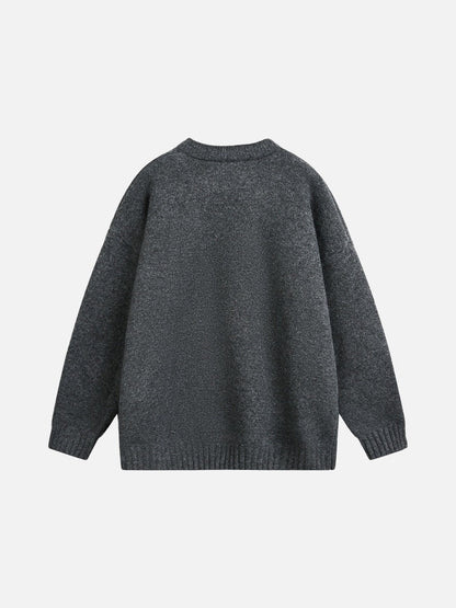 Relaxed light grey knitted jumper laid flat