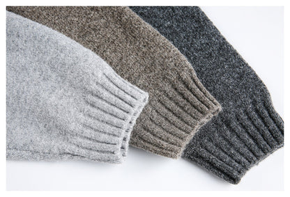 Detailed view of the neckline on a light grey knit jumper