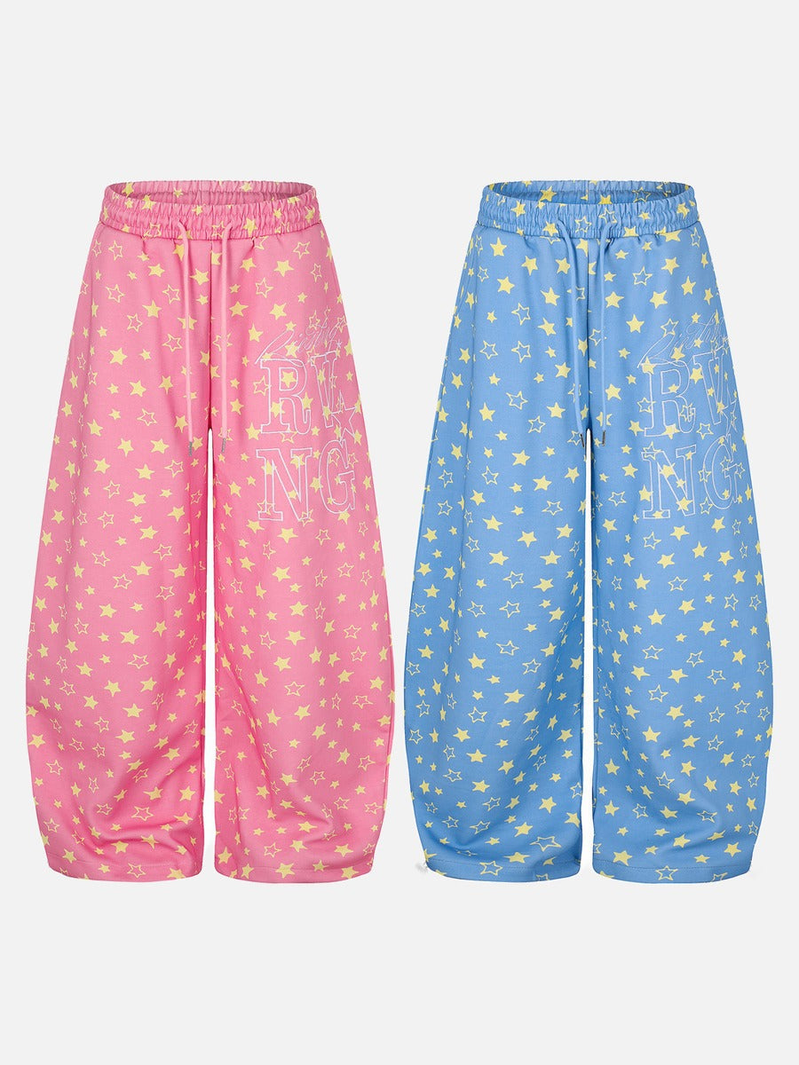 Close-up of the waistband and fit of star print wide-leg trousers