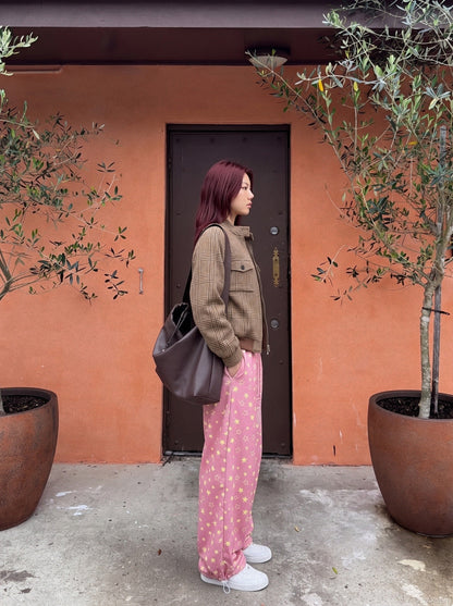 Wide-leg star print trousers shown in a relaxed full-length view