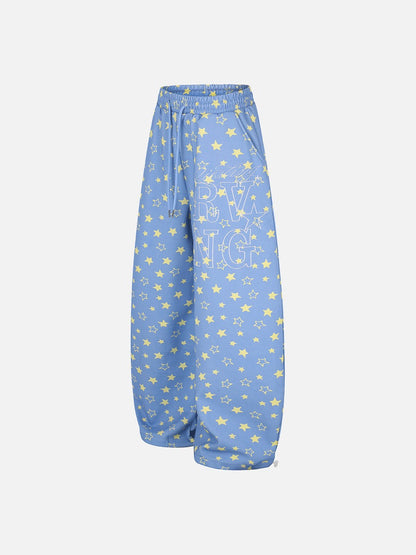 Wide-leg star print trousers displayed flat to show overall shape