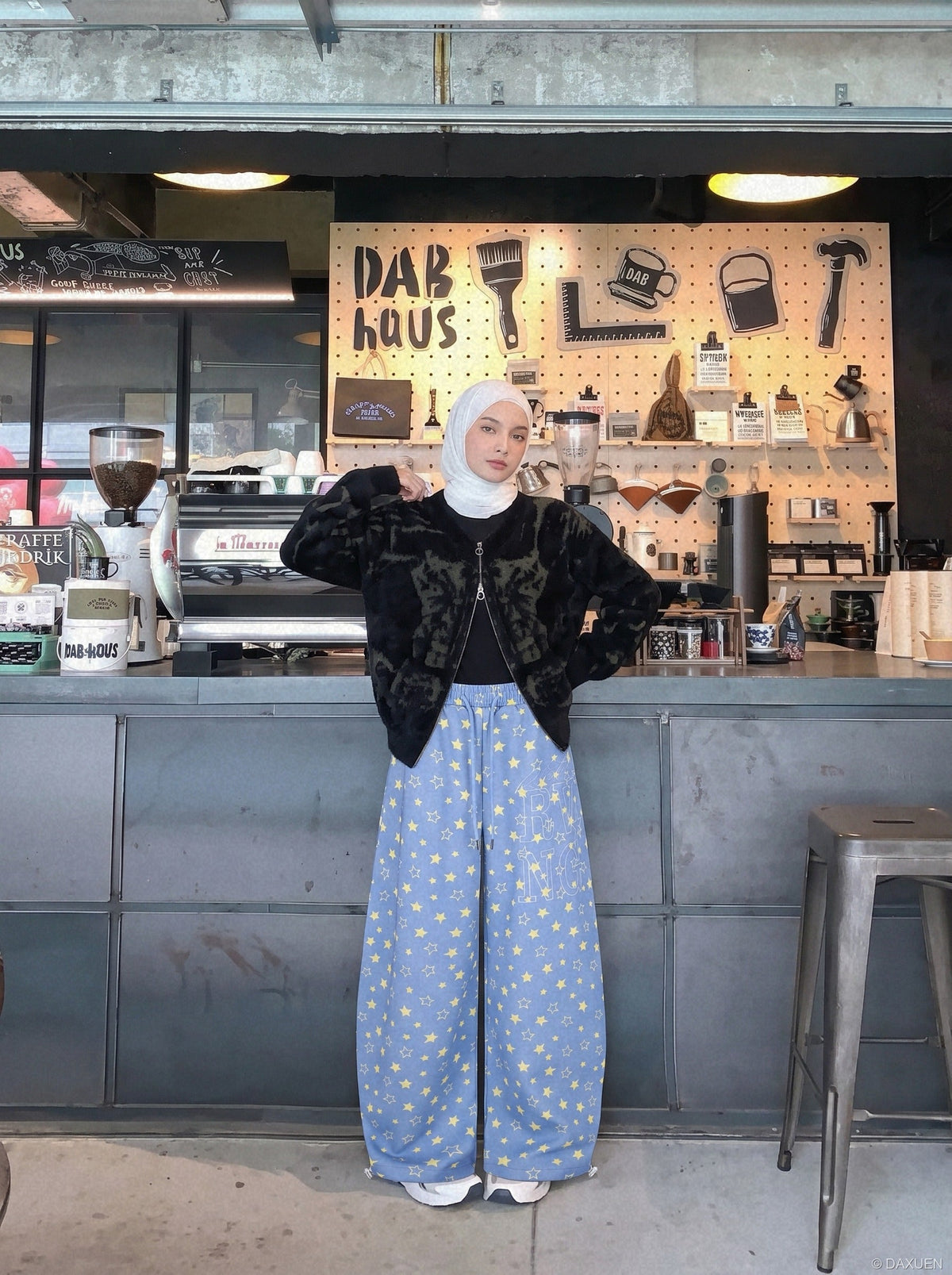 Close-up of drawstring waist on star print wide-leg trousers
