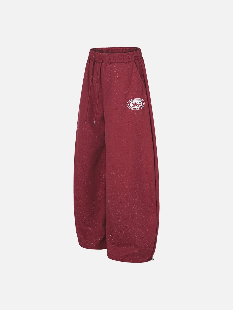 Angled view of wide-leg embroidered fleece sweatpants