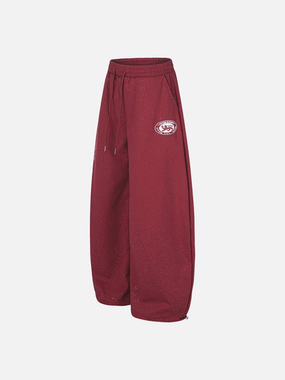 Angled view of wide-leg embroidered fleece sweatpants