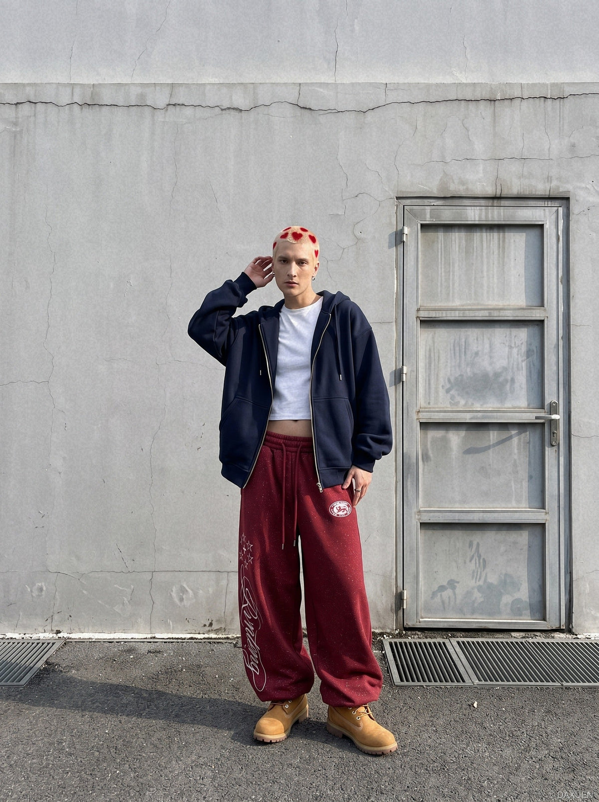 Side view of wide-leg fleece sweatpants showing embroidered detail