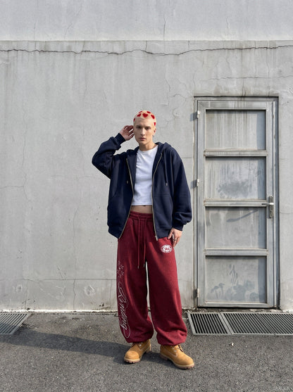Side view of wide-leg fleece sweatpants showing embroidered detail