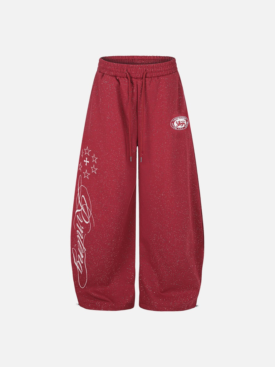 Rear view of wide-leg embroidered fleece sweatpants with soft drape