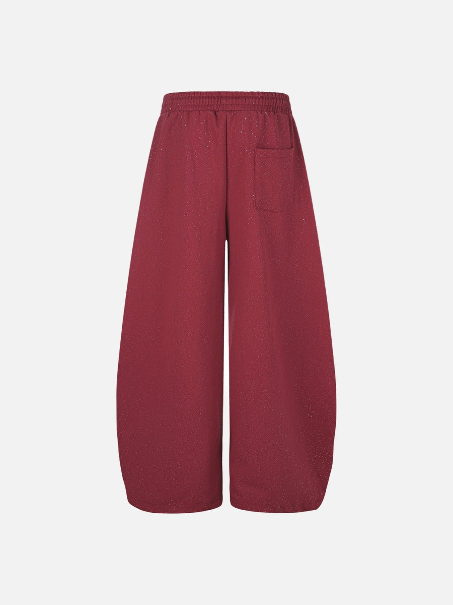 Detailed view of stitching and embroidery on fleece sweatpants