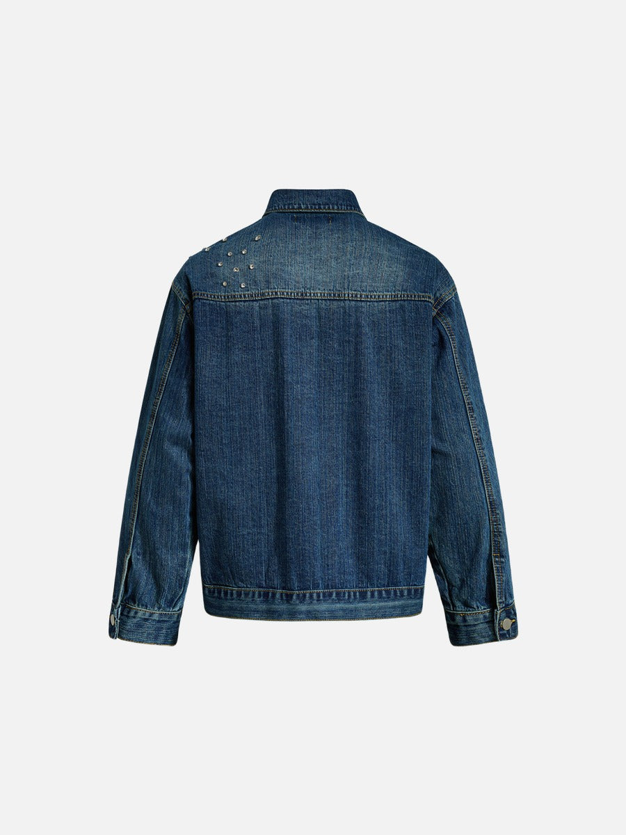 Close-up of studs on a vintage black denim jacket