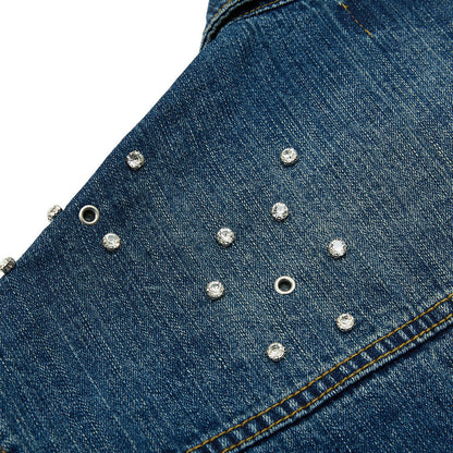 Side view of a vintage studded denim jacket in blue