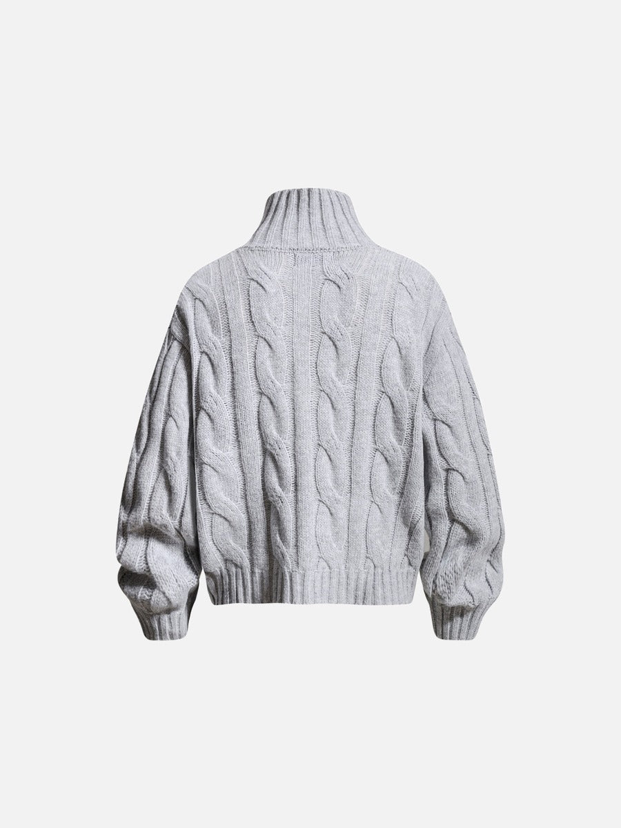 Sleeve and cuff detail on a cable knit jumper