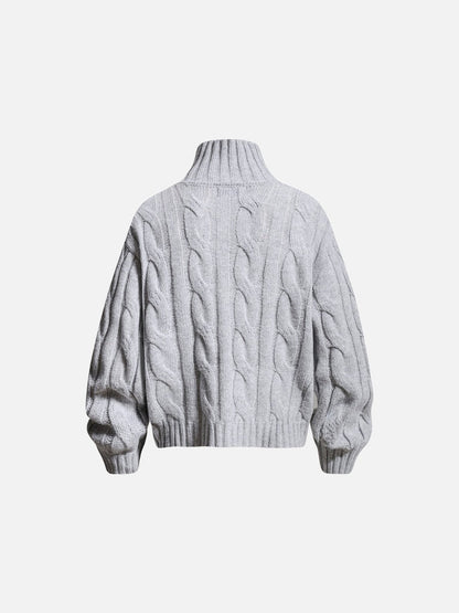 Sleeve and cuff detail on a cable knit jumper