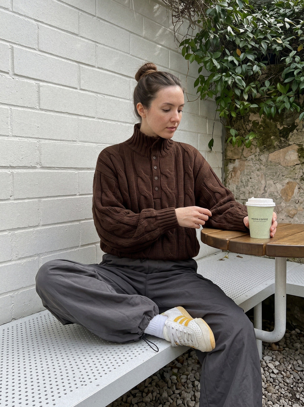 Cable knit jumper showing the high mock neck design