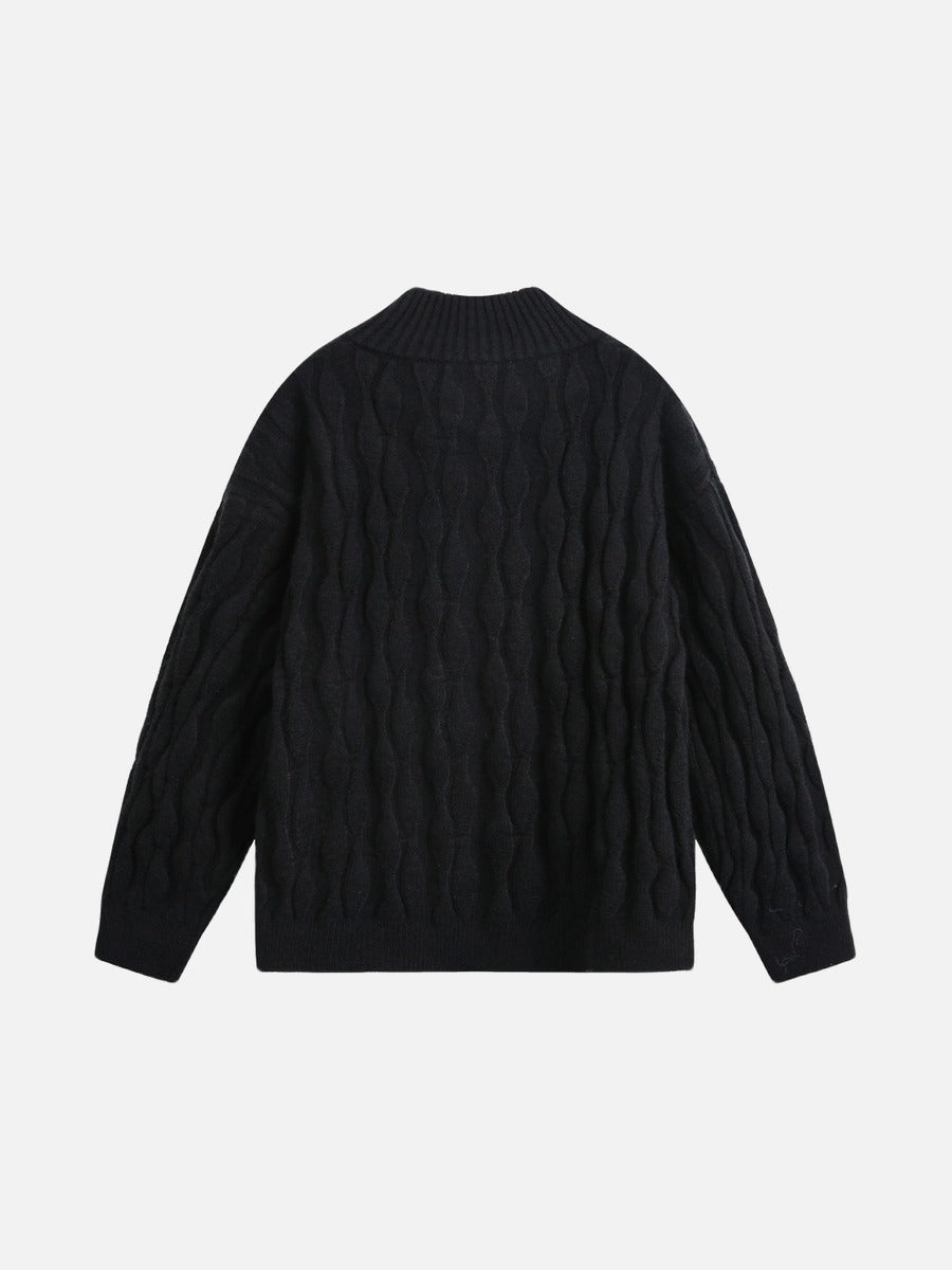 Close-up of the jumper’s cable knit sleeve texture