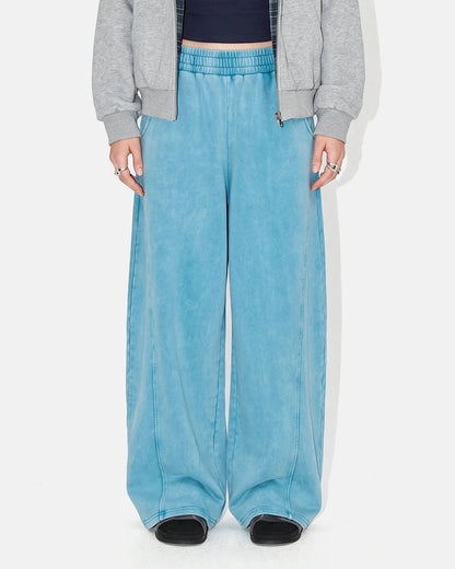 Acid-washed barrel sweatpants shown from the back