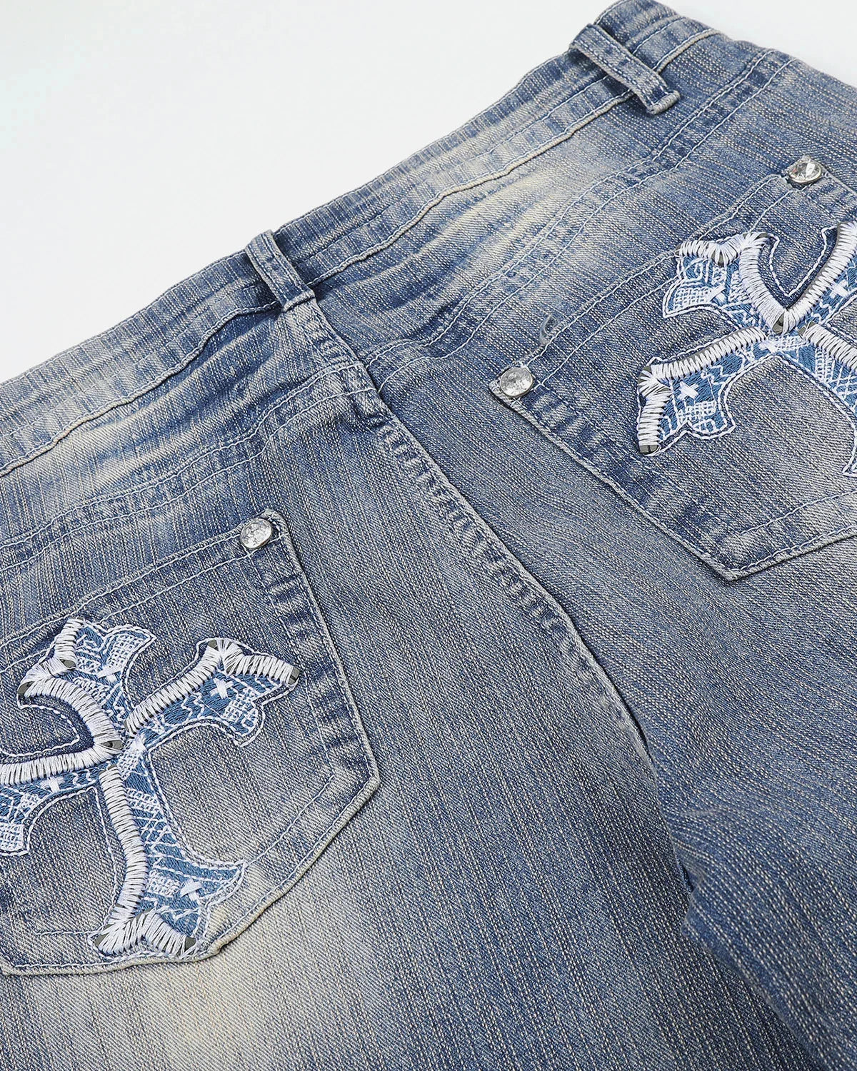 Detailed view of bamboo-weave trim on bootcut jeans