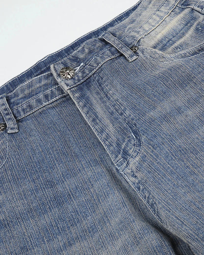 Waist and pocket detail on embroidered bootcut jeans