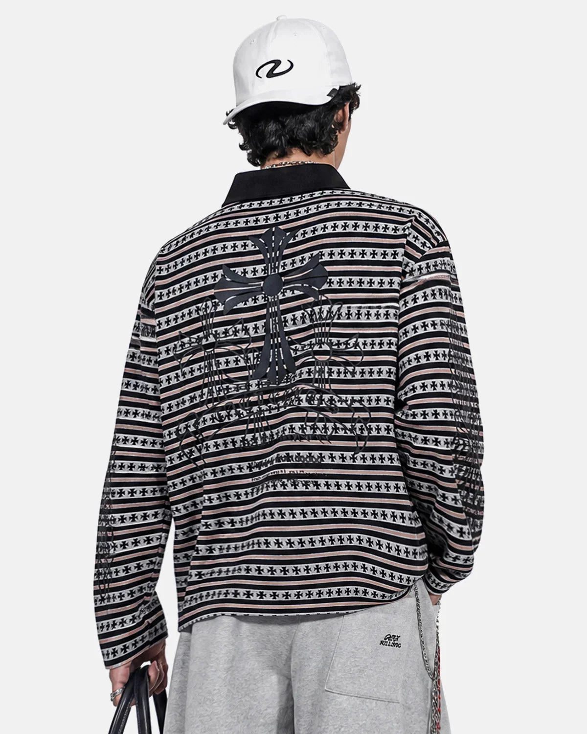 Full view of the cross graphic striped polo shirt
