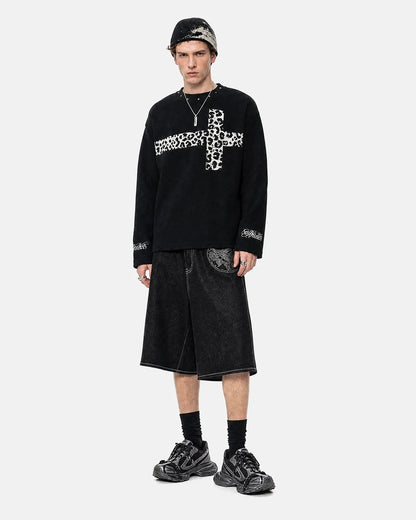 Close-up of the leopard graphic and cross design on the T-shirt