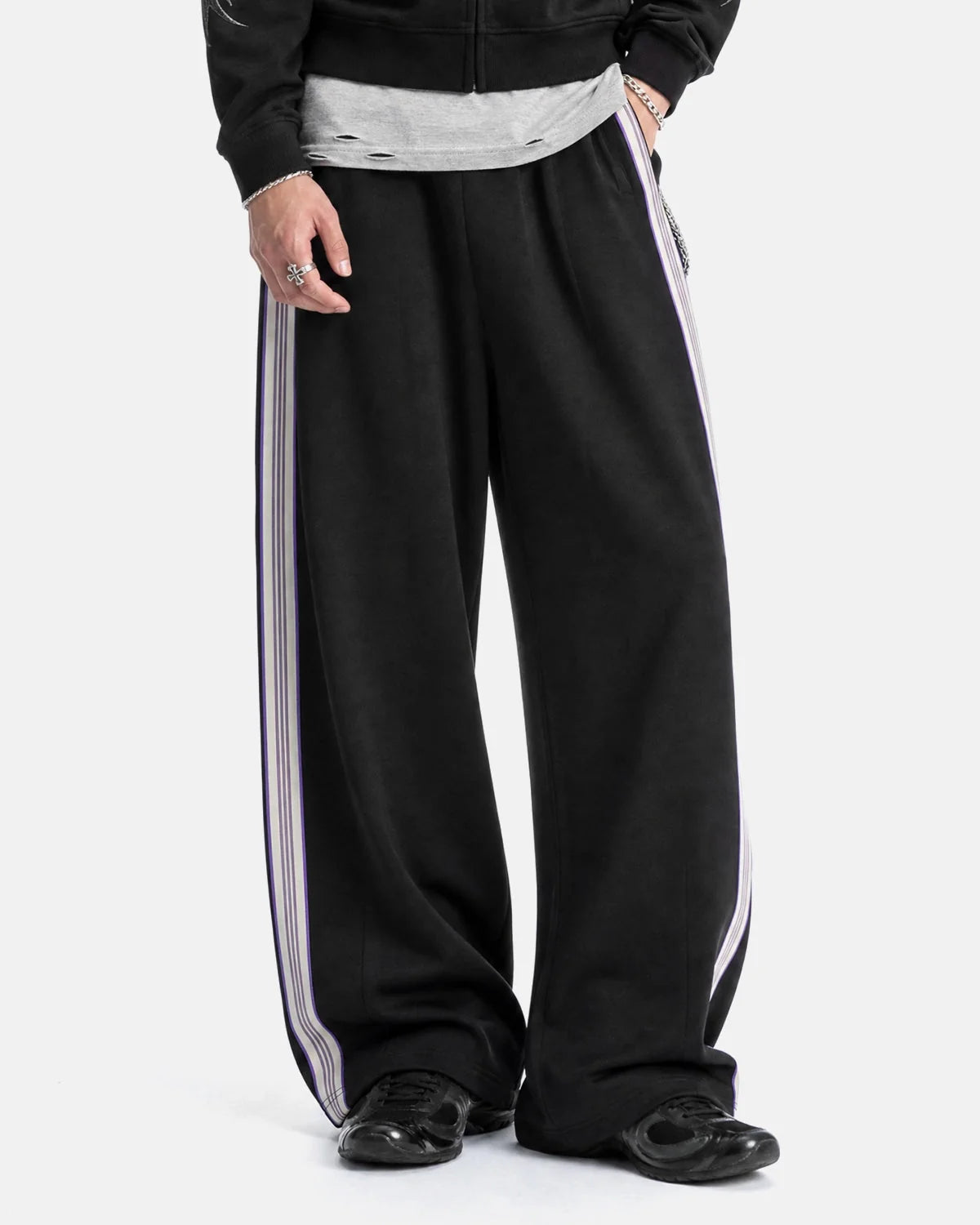 Side view of wide-leg track trousers showing the stripe