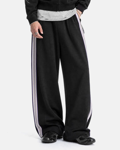 Side view of wide-leg track trousers showing the stripe