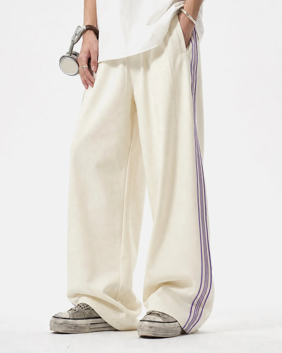 Wide-leg track trousers showing the comfortable loose fit