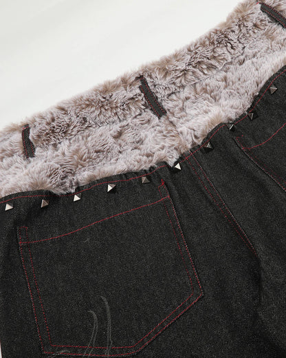 Detail of decorative studs arranged along the jeans waistband
