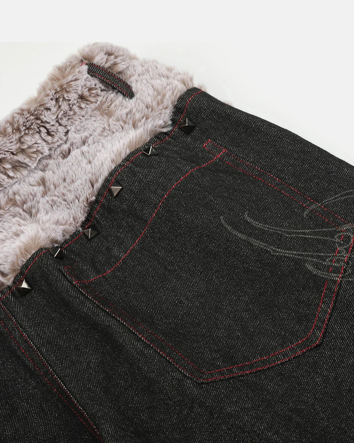 Back view of studded faux fur waistband baggy jeans