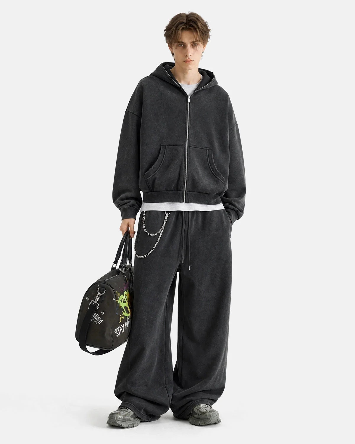 Side view showing the loose silhouette of the sweatpants